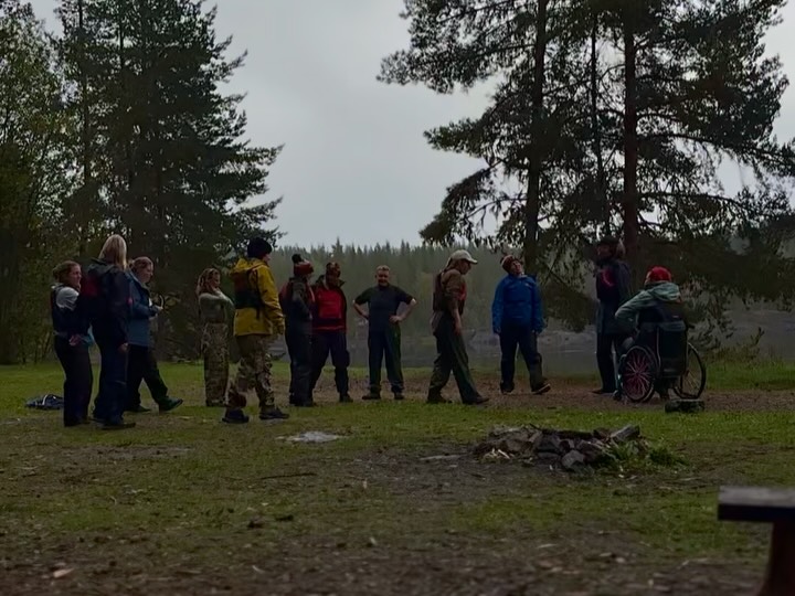 Group gathered around a campfire in the forest